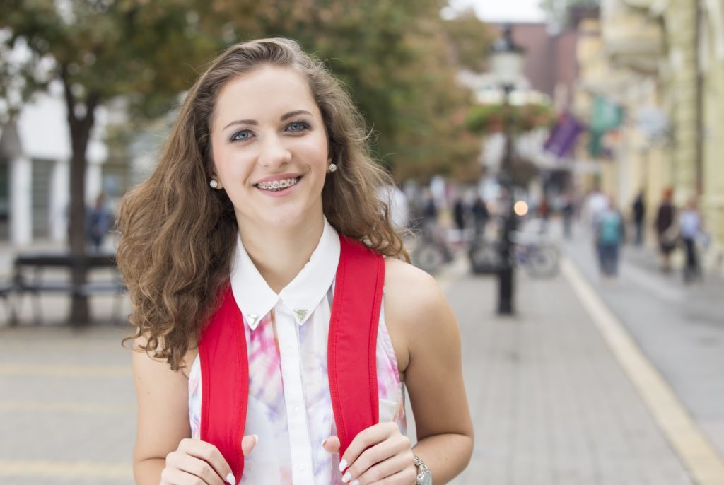 teen with red backpack