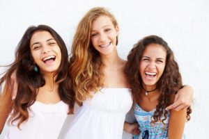 teen girls smiling and laughing with braces