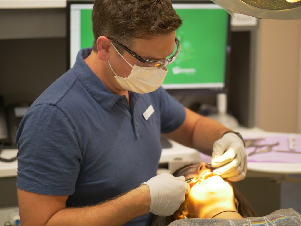 Dr. Sears working with a patient