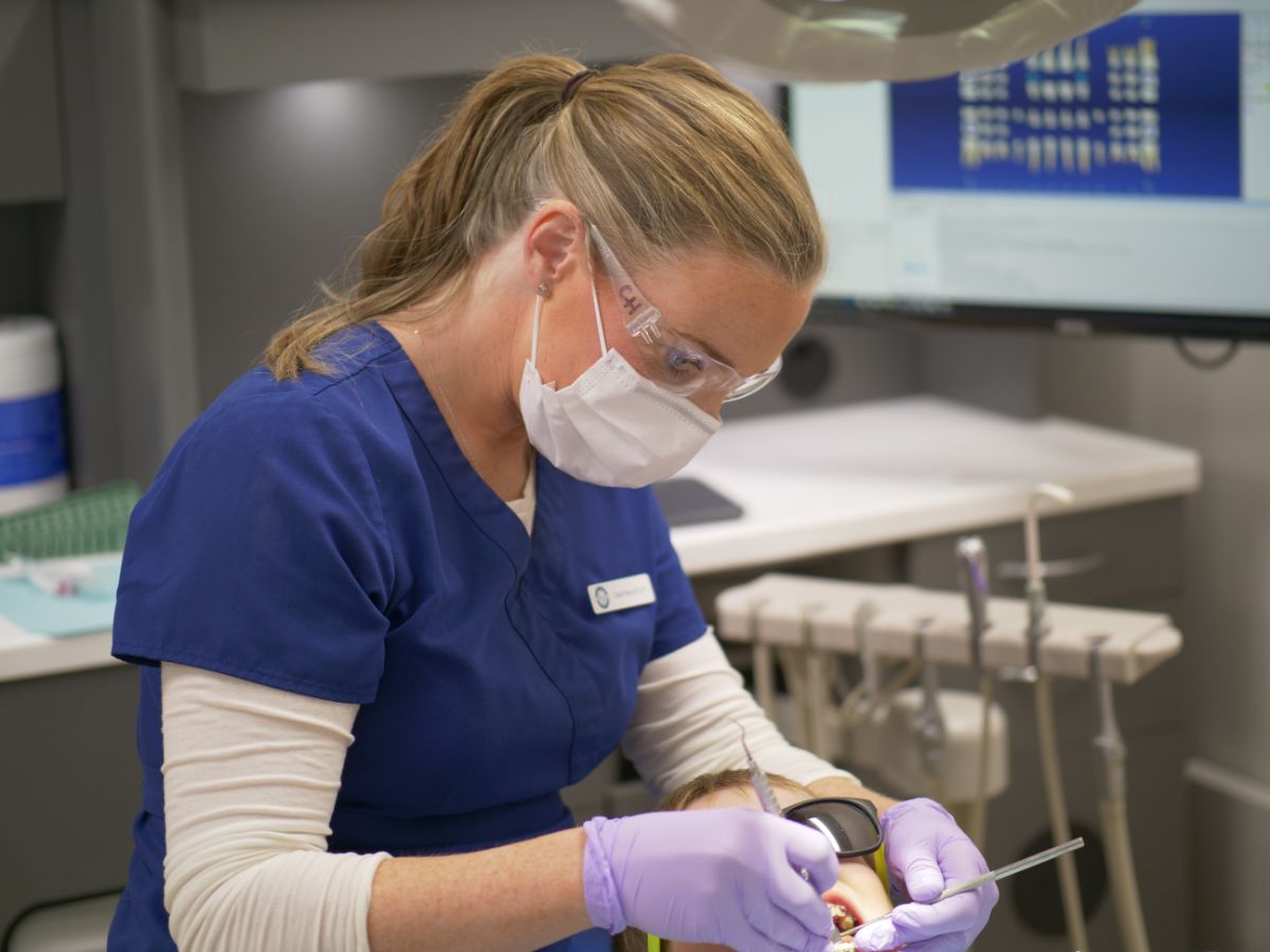 assistant working on patient