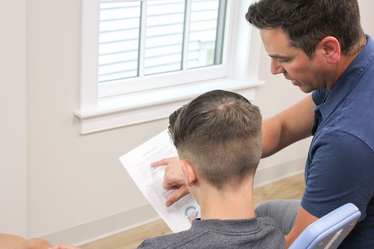 Dr. Sears showing a patient tips for going back to school with braces
