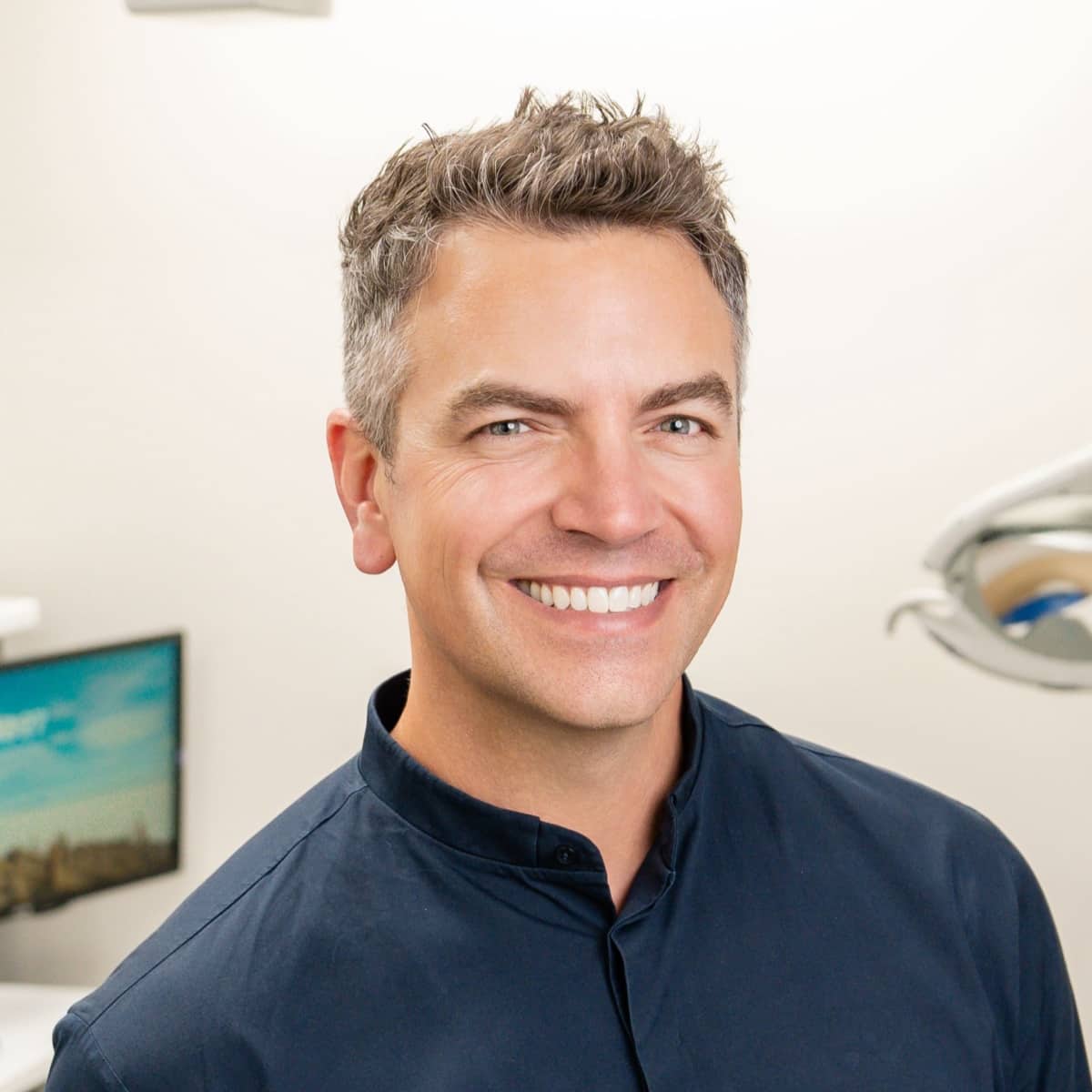 Dr. Chad Sears, orthodontist in Lexington, smiling in dental office, showcasing expertise in orthodontics and pediatric dentistry.