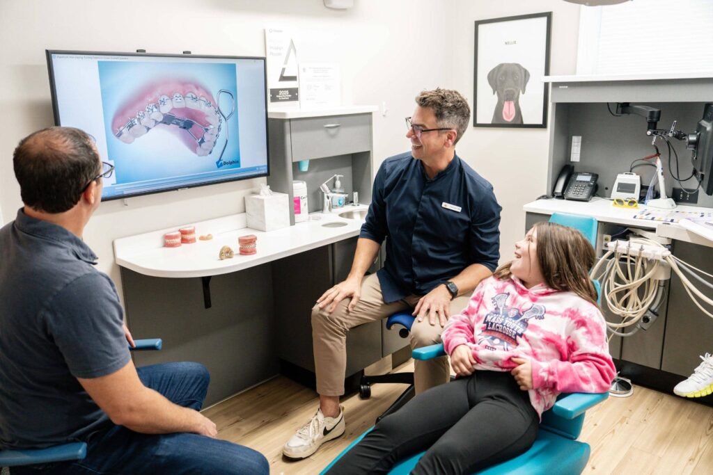 Early orthodontic checkup for kids at Coppe + Sears Lexington Orthodontist examining a child's teeth during an early orthodontic evaluation in Lexington, MA